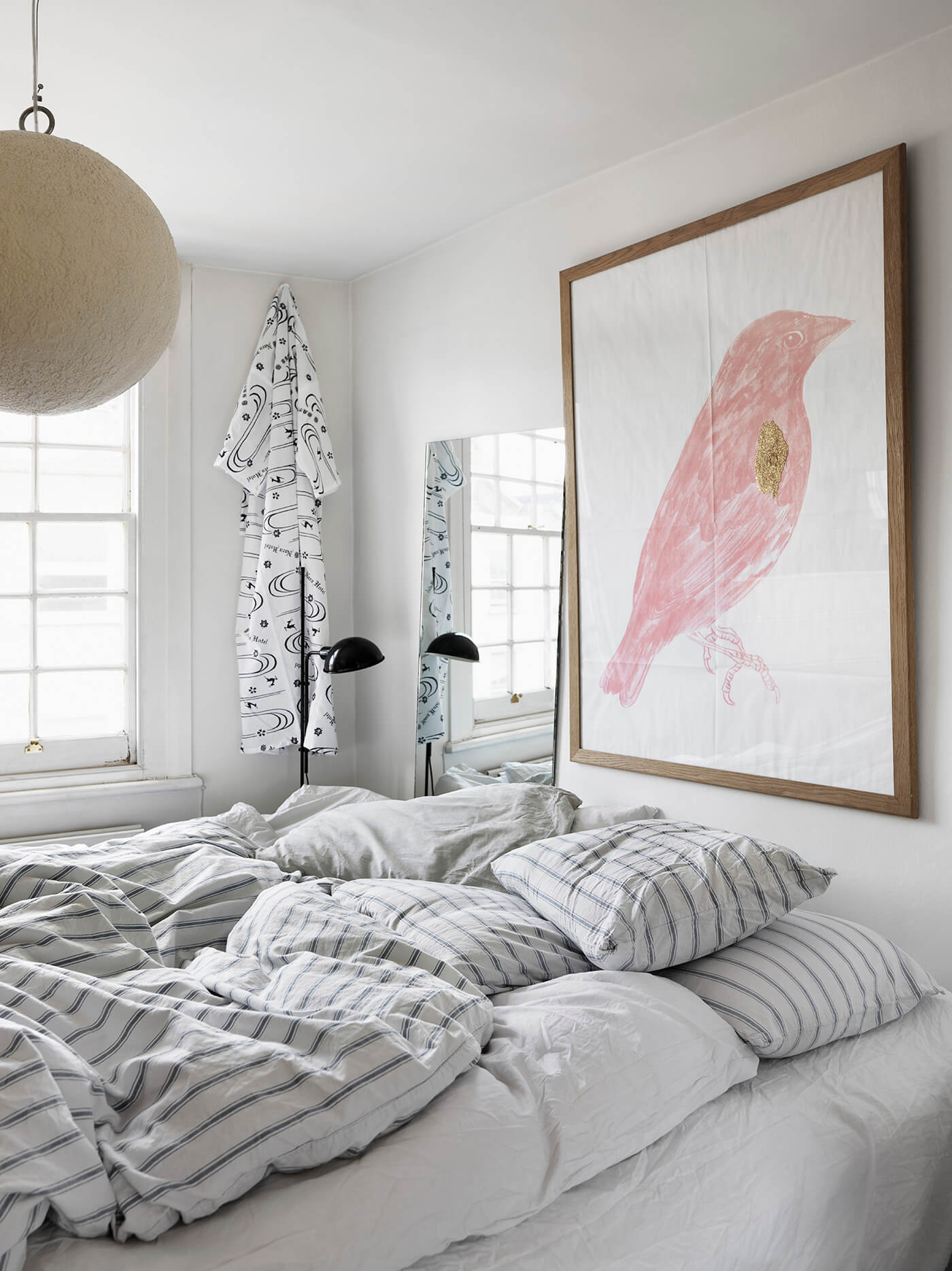 White bedroom with a big artwork