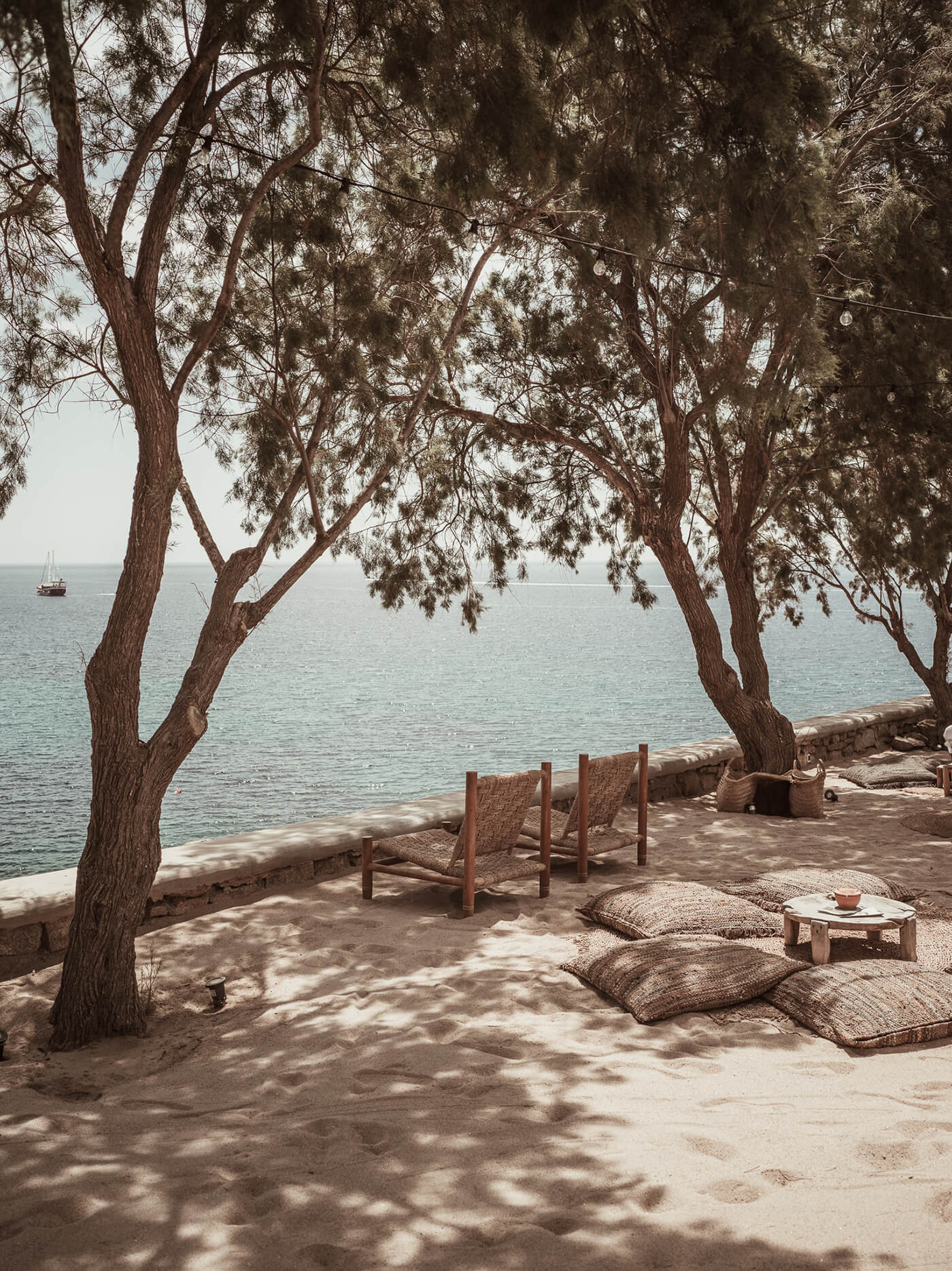Two chairs in the shadow overlooking the sea